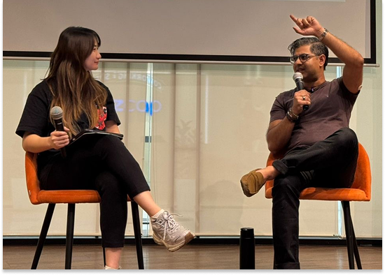 Ash Ali speaking on stage in Southeast Asia